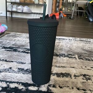 Green studded Starbucks cup